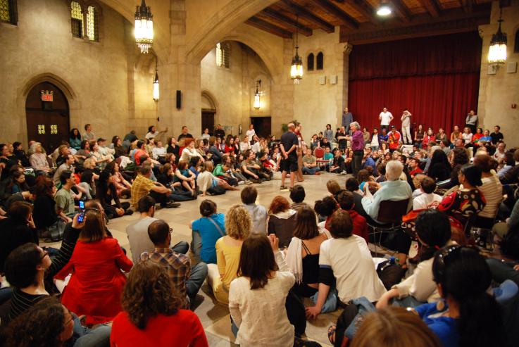 A large group of people take part in a "Theatre of the Oppressed" workshop