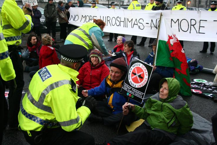 A group of protesters working together to blockade a nuclear weapons factory in the UK